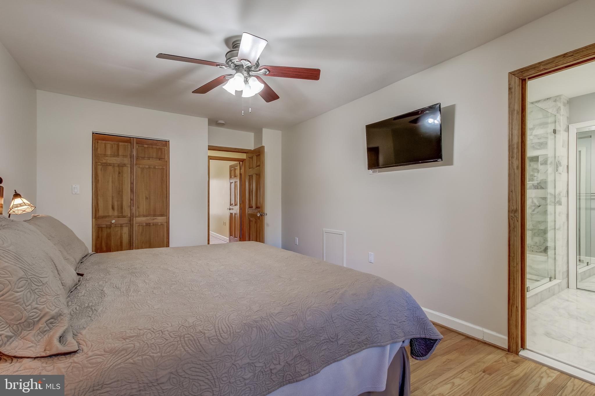 8120 Inverness Ridge Road Potomac, MD 20854 - Photo 29 of 42 a bedroom with a bed and a flat screen tv