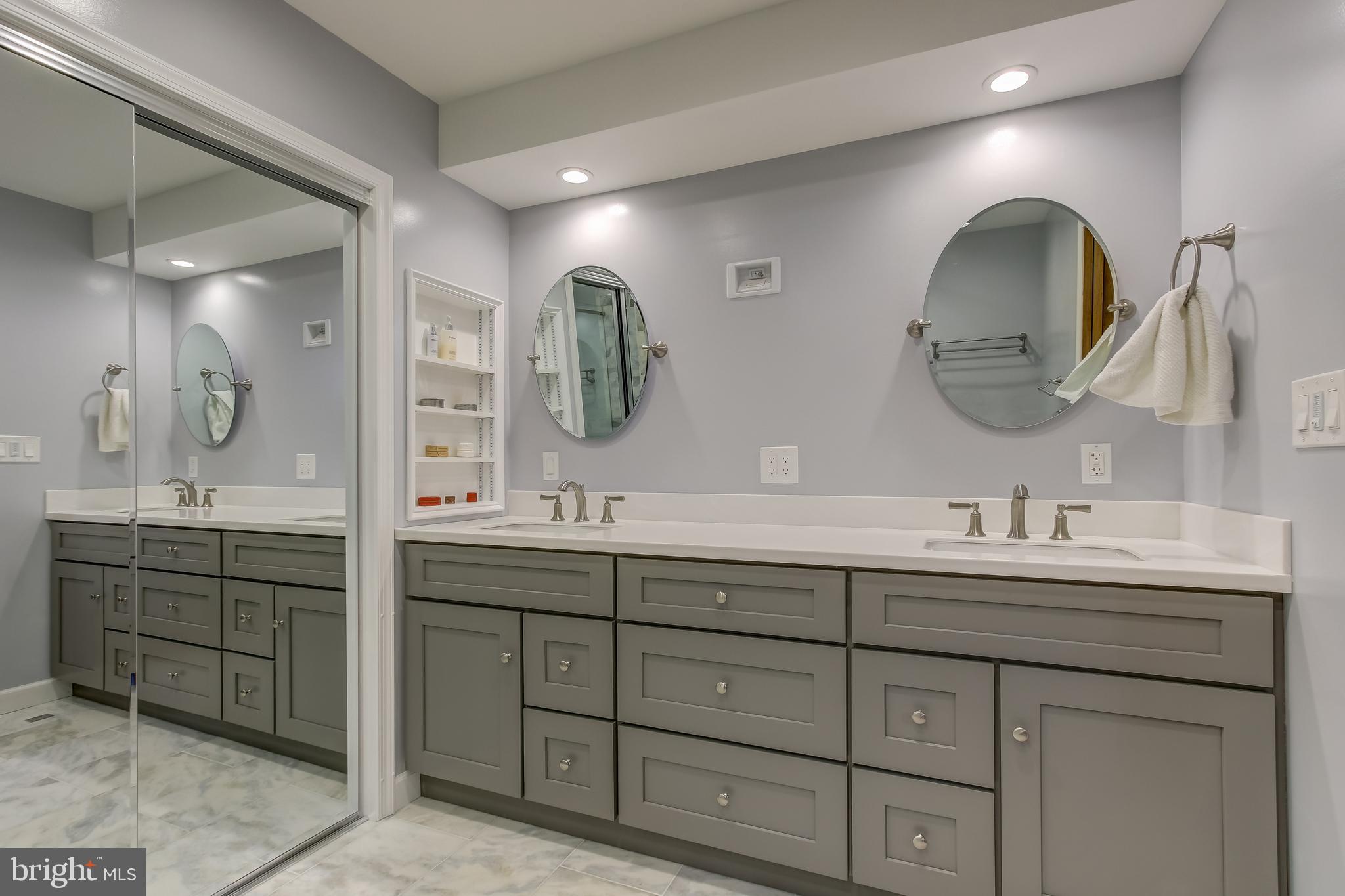 8120 Inverness Ridge Road Potomac, MD 20854 - Photo 31 of 42 a bathroom with a double vanity sink and a mirror