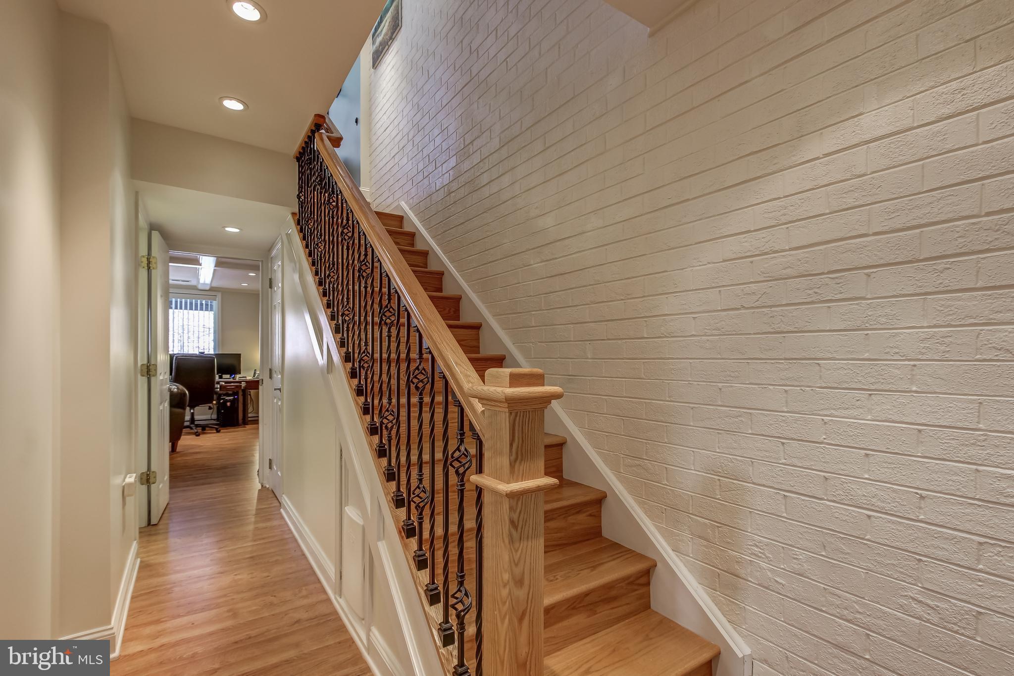 8120 Inverness Ridge Road Potomac, MD 20854 - Photo 32 of 42 a view of a hallway with wooden floor and stairs