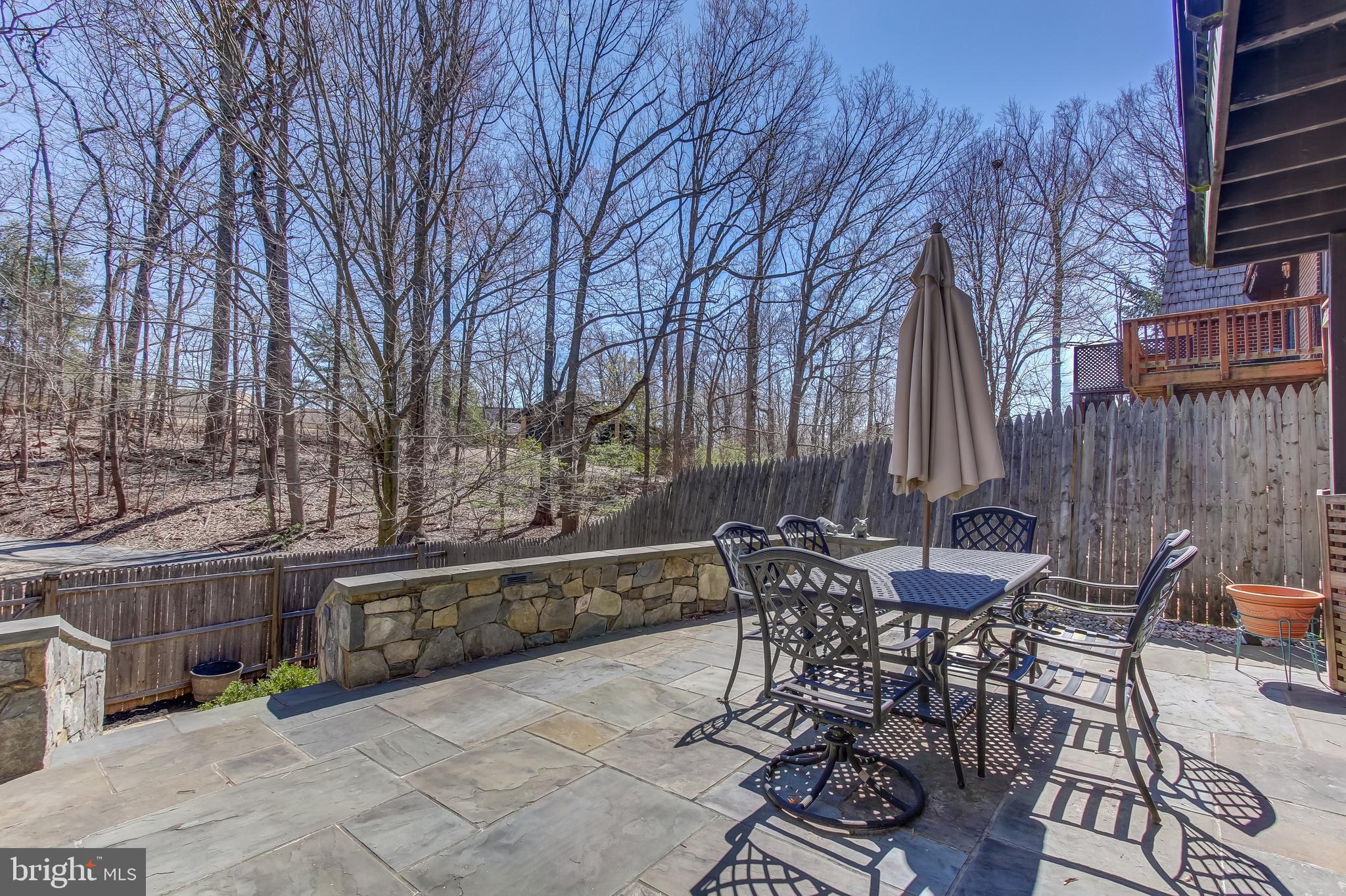 8120 Inverness Ridge Road Potomac, MD 20854 - Photo 38 of 42 a view of a patio with table and chairs and wooden fence