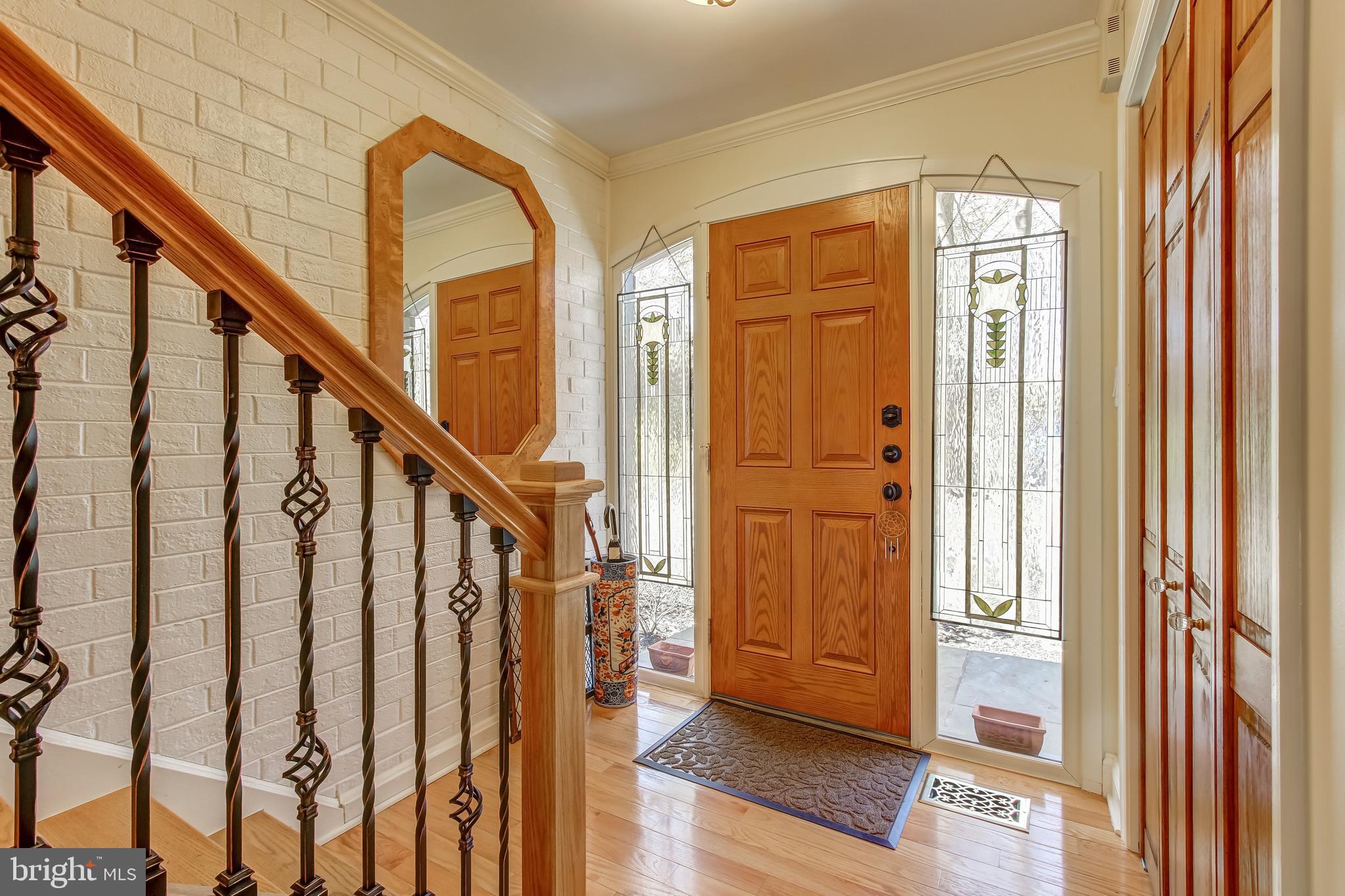 8120 Inverness Ridge Road Potomac, MD 20854 - Photo 5 of 42 a view of an entryway with wooden floor and door