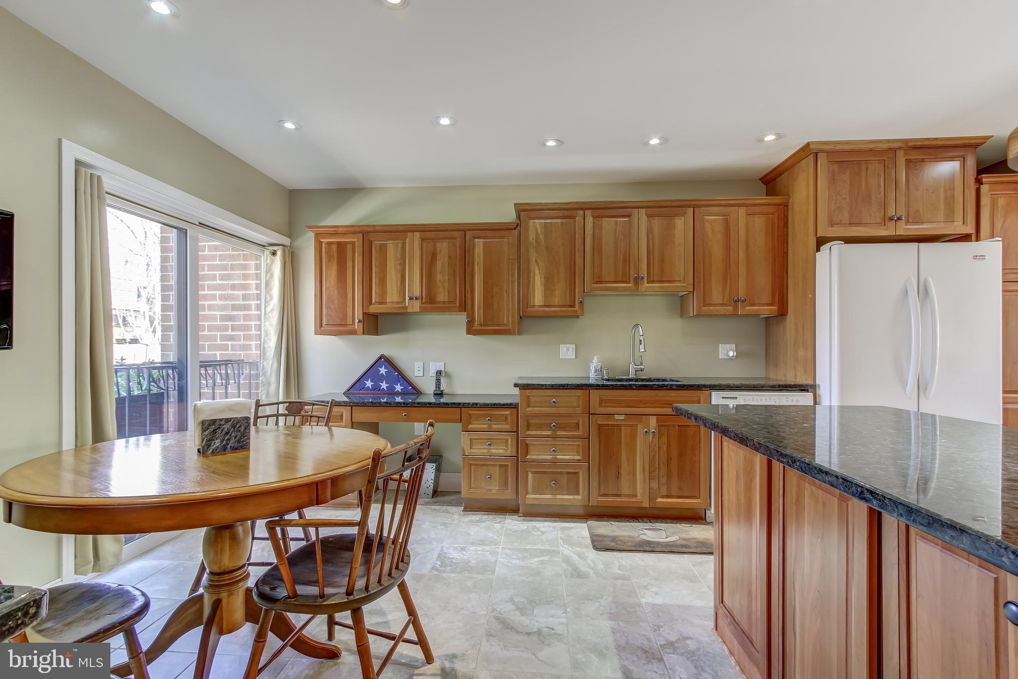 8120 Inverness Ridge Road Potomac, MD 20854 - Photo 6 of 42 a kitchen with stainless steel appliances granite countertop a stove top oven a sink a refrigerator and a granite counter tops