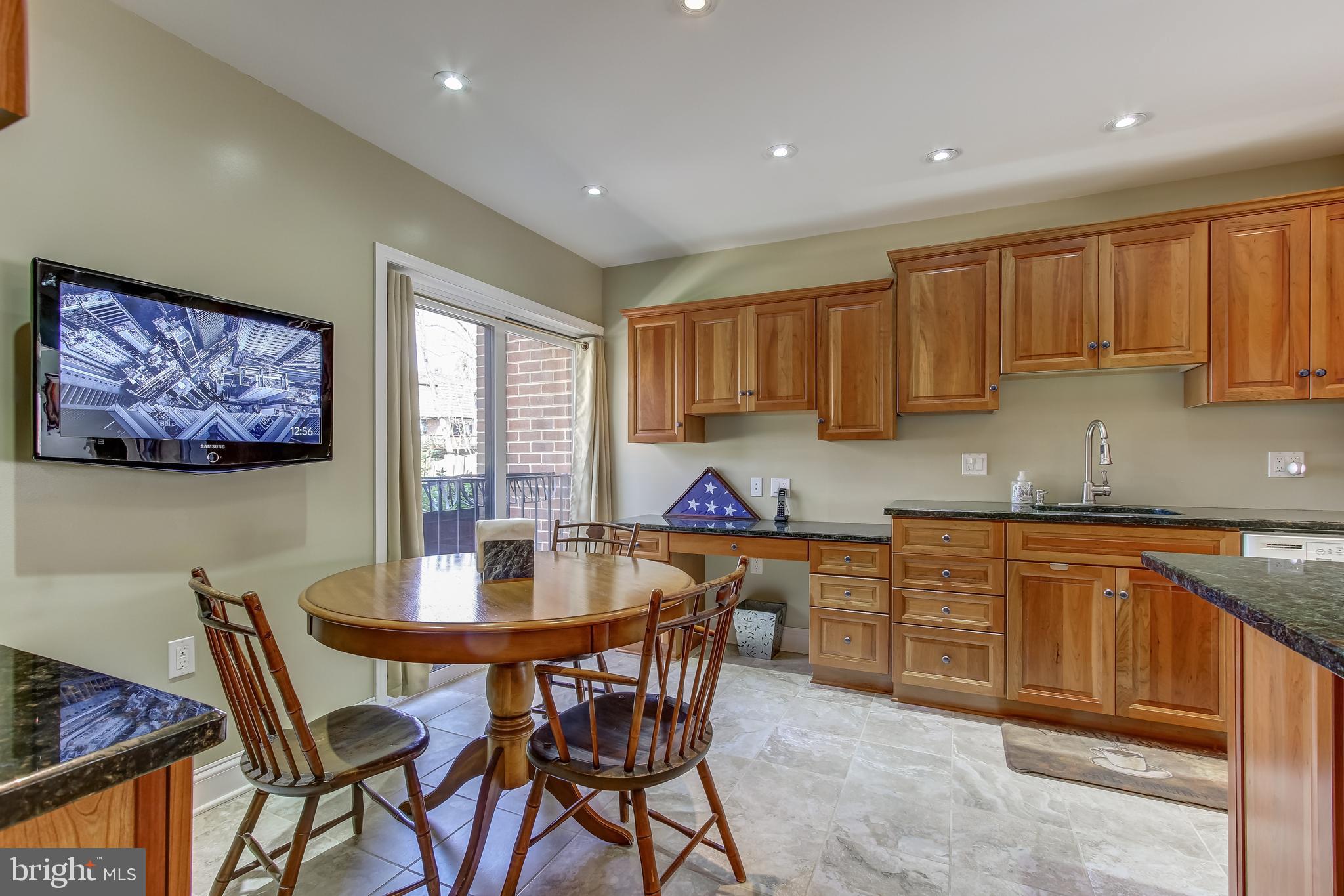 8120 Inverness Ridge Road Potomac, MD 20854 - Photo 7 of 42 a kitchen with a dining table chairs and cabinets
