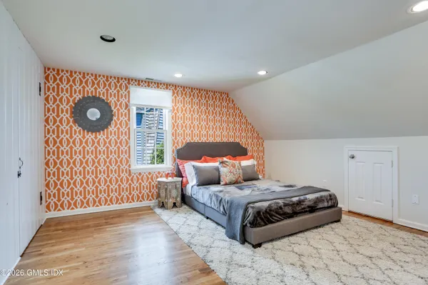 a bedroom with a bed and a window