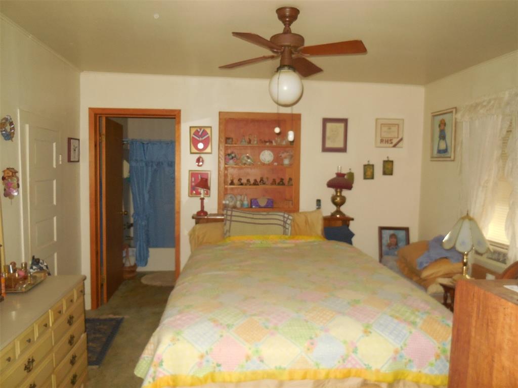 610 West Main Street Ranger, TX 76470 - Photo 3 of 17 Carpeted bedroom featuring a closet, ceiling fan, and a spacious closet