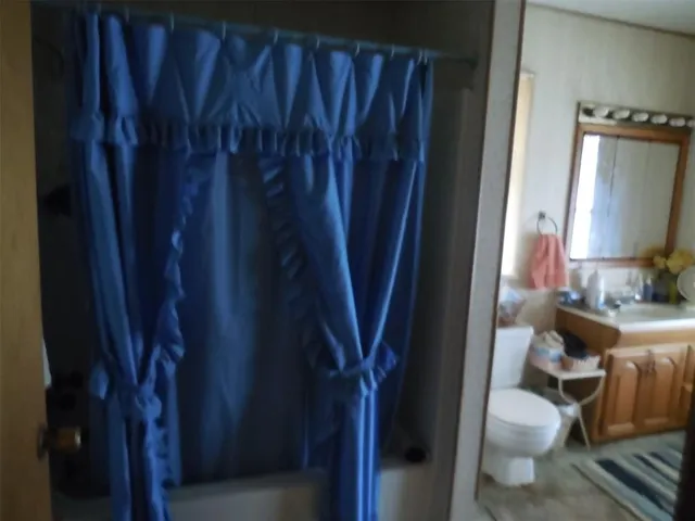 a bathroom with a toilet and a mirror