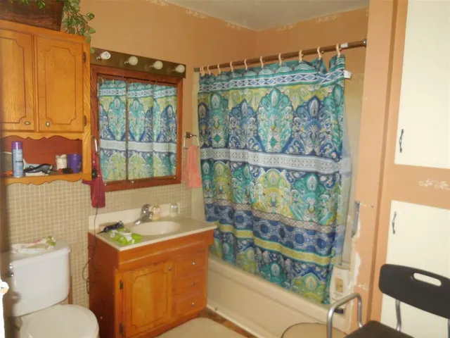 a bathroom with a toilet sink and tub