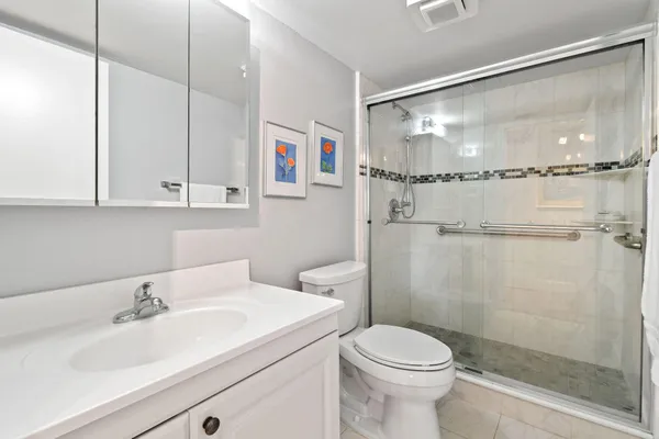 a bathroom with a sink toilet and shower