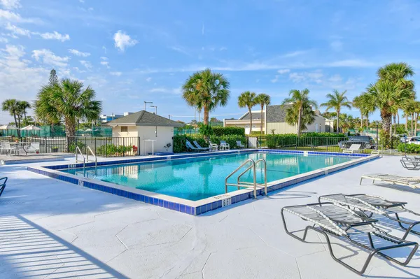 a view of swimming pool with a lounge chairs