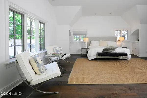 a living room with furniture fireplace and a large window