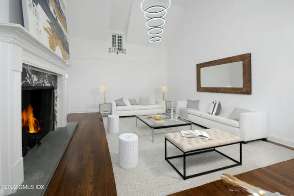 a living room with furniture and a lamp