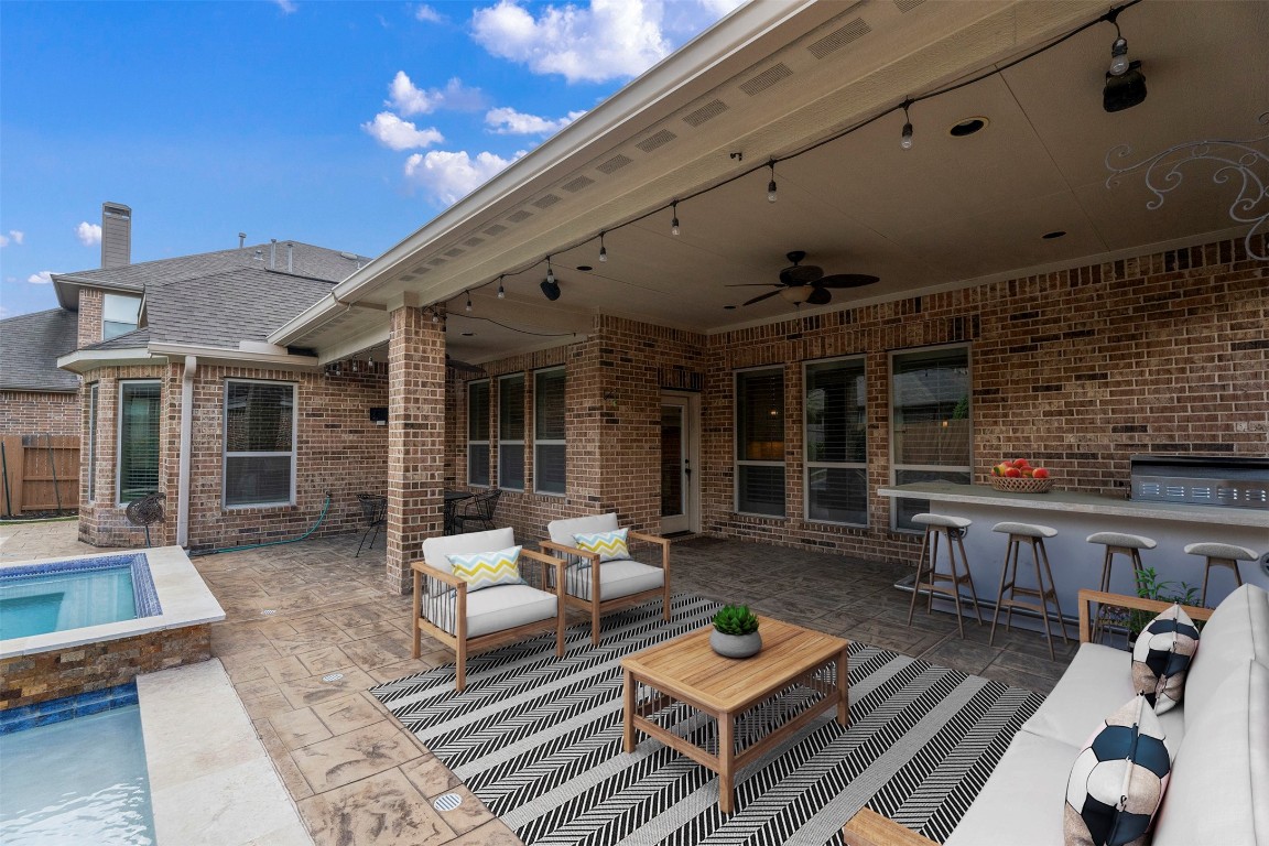 28507 Rose Vervain Drive Spring, TX 77386 - Photo 6 of 50 600 SF of covered outdoor space, outdoor kitchen with bar seating. Furniture is virtually staged.