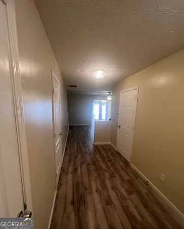a view of hallway with wooden floor