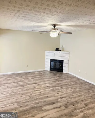 a view of a room with wooden floor and a fireplace