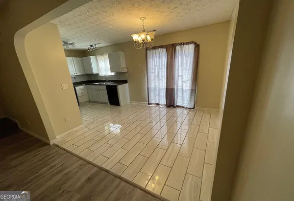 a view of a kitchen from the hallway
