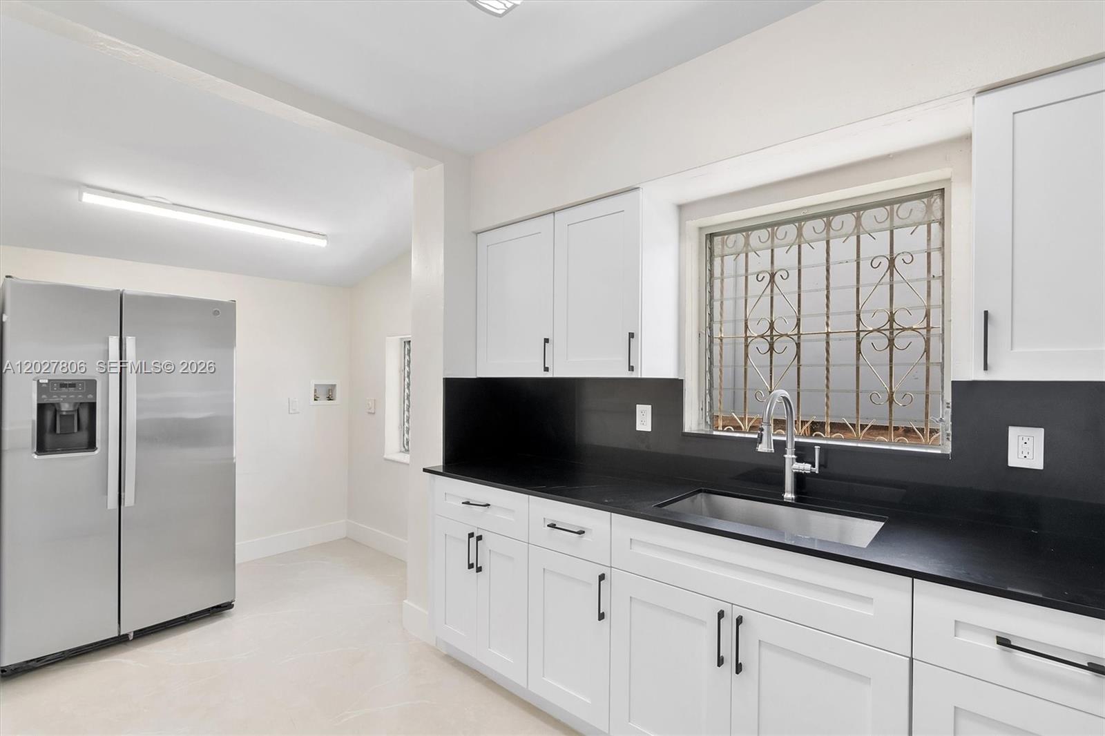 1612 Southwest 23rd Street, Unit 1612 Miami, FL 33145 - Photo 15 of 42 a kitchen with stainless steel appliances a sink a refrigerator and cabinets
