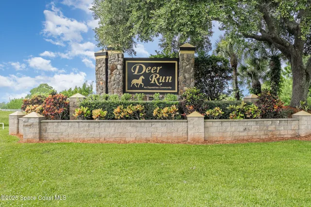 a view of sign board with tall trees
