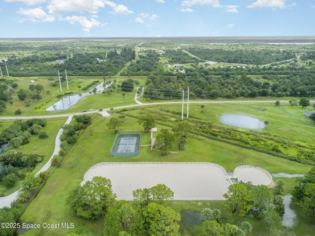 an aerial view of a houses with outdoor space and a lake view