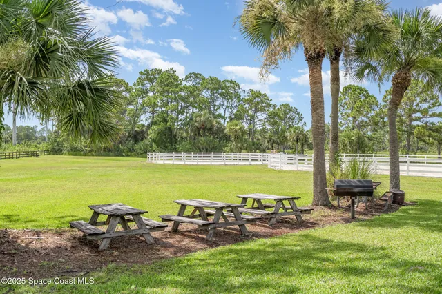 a view of a swimming pool with a garden and seating area