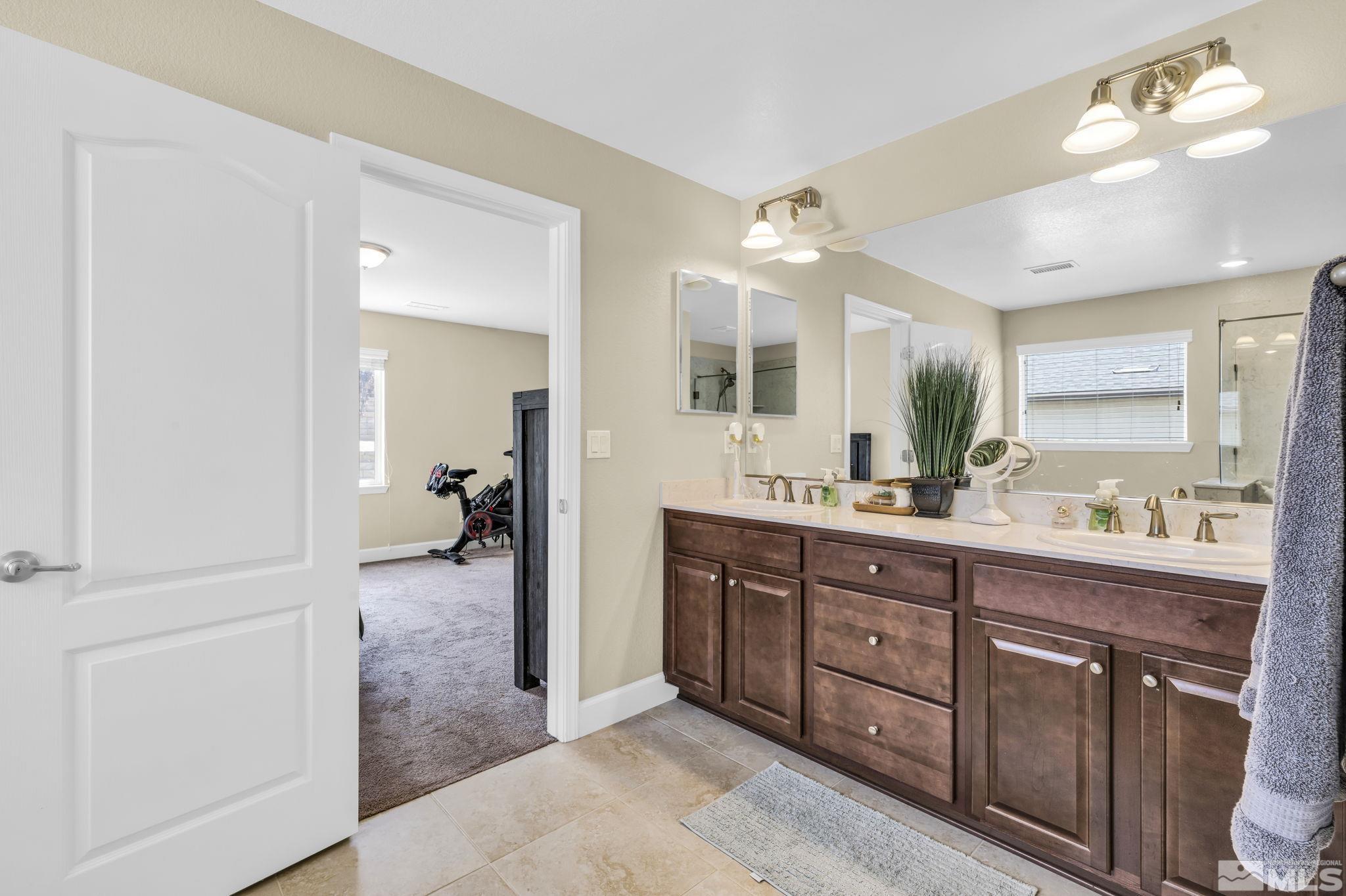 6508 Copper Mountain Drive Carson City, NV 89701 - Photo 11 of 40 a spacious en suite bathroom with a double vanity sink and mirror