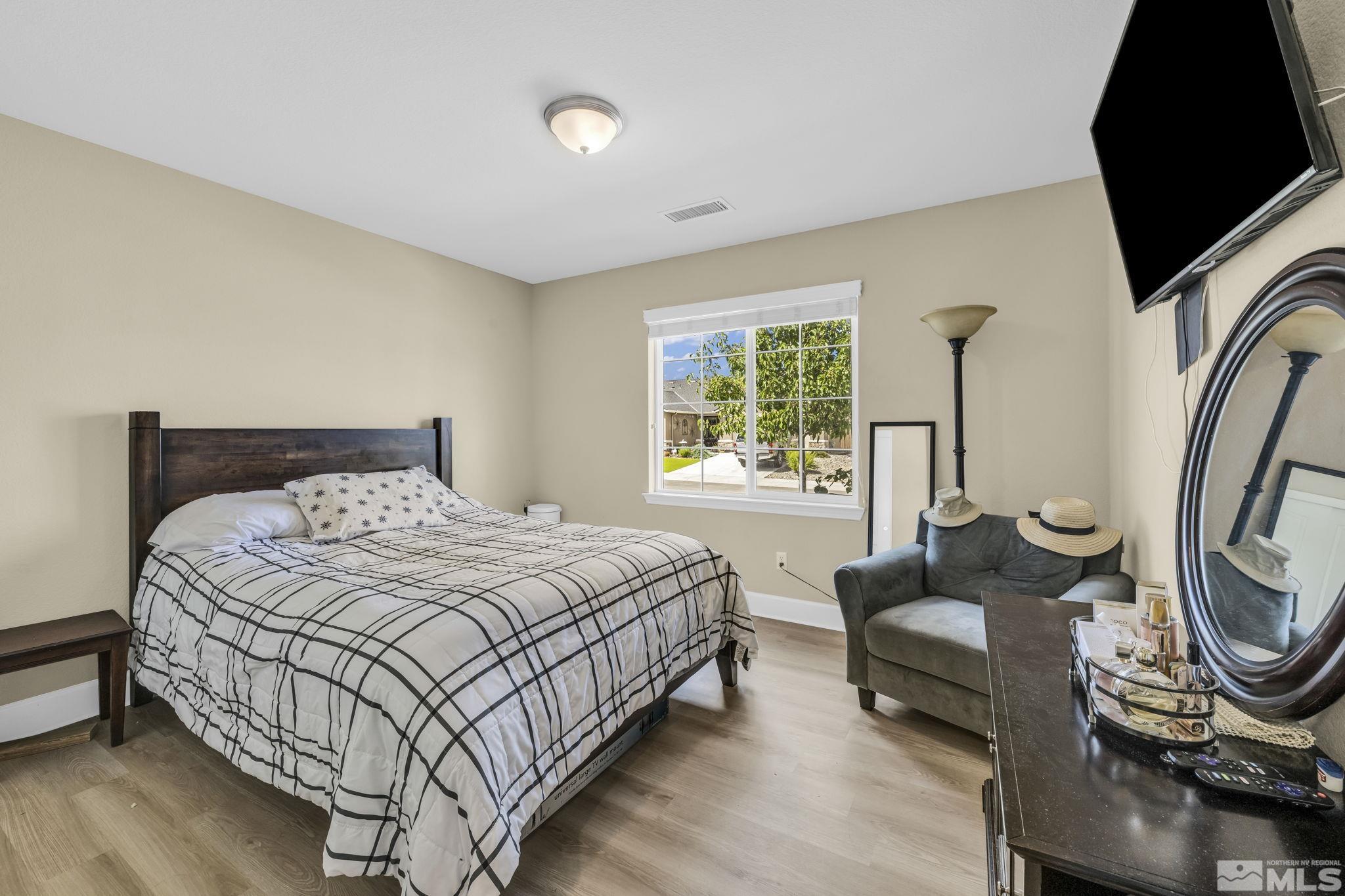 6508 Copper Mountain Drive Carson City, NV 89701 - Photo 14 of 40 a bedroom with a bed a mirror and a window