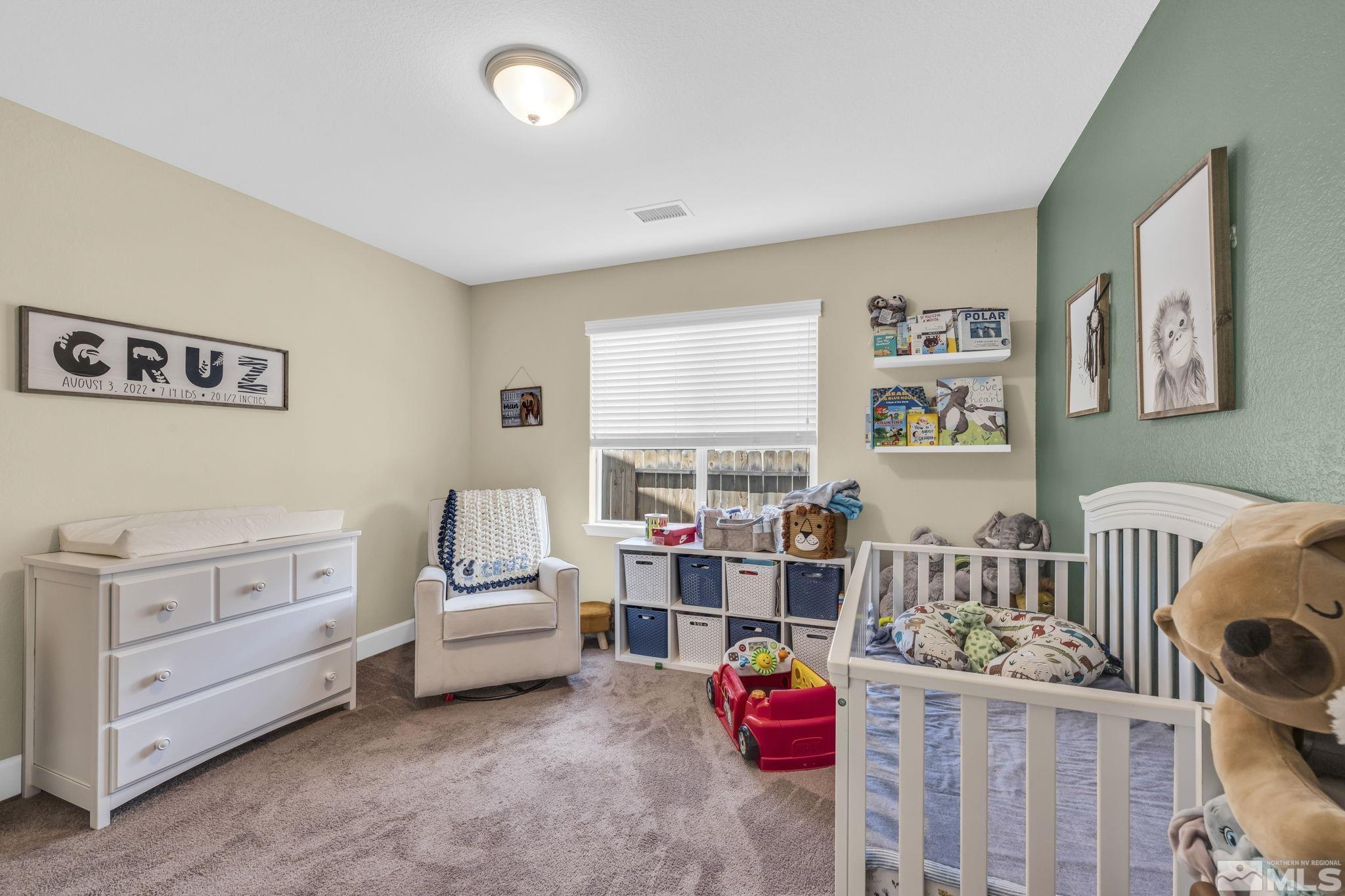 6508 Copper Mountain Drive Carson City, NV 89701 - Photo 15 of 40 a bedroom with furniture and a baby crib
