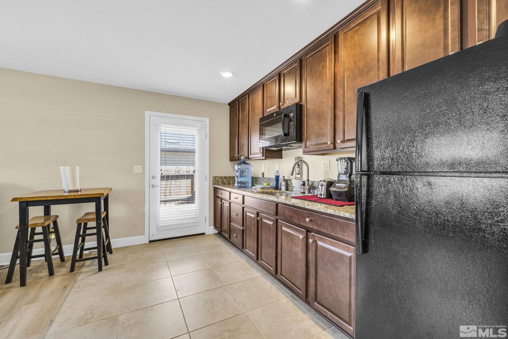 6508 Copper Mountain Drive Carson City, NV 89701 - Photo 19 of 40 a kitchen with stainless steel appliances granite countertop a refrigerator and a stove top oven