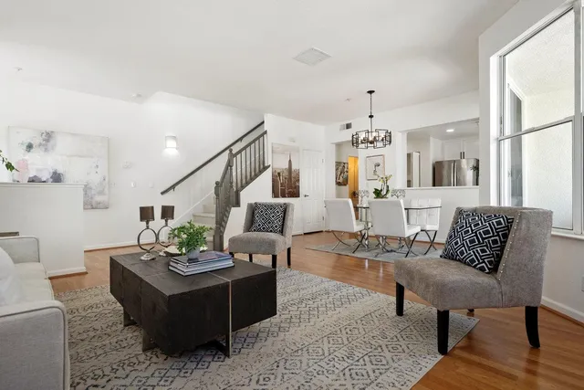 a living room with furniture or chandelier and a wooden floor