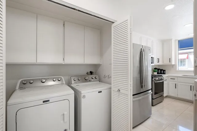 a view of a storage and utility room with closet dryer