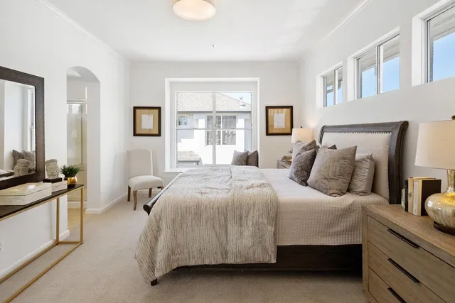 a living room with furniture and a mirror