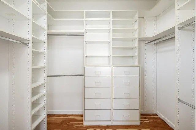 a bedroom with a bed mirror and a table