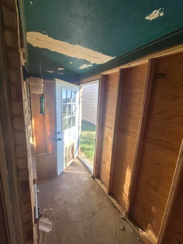 a view of backyard with wooden fence