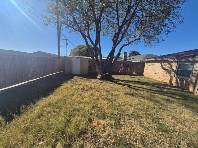a view of backyard with cabin