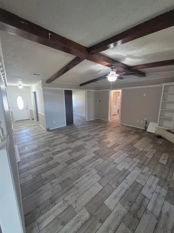 a view of a room with wooden floor