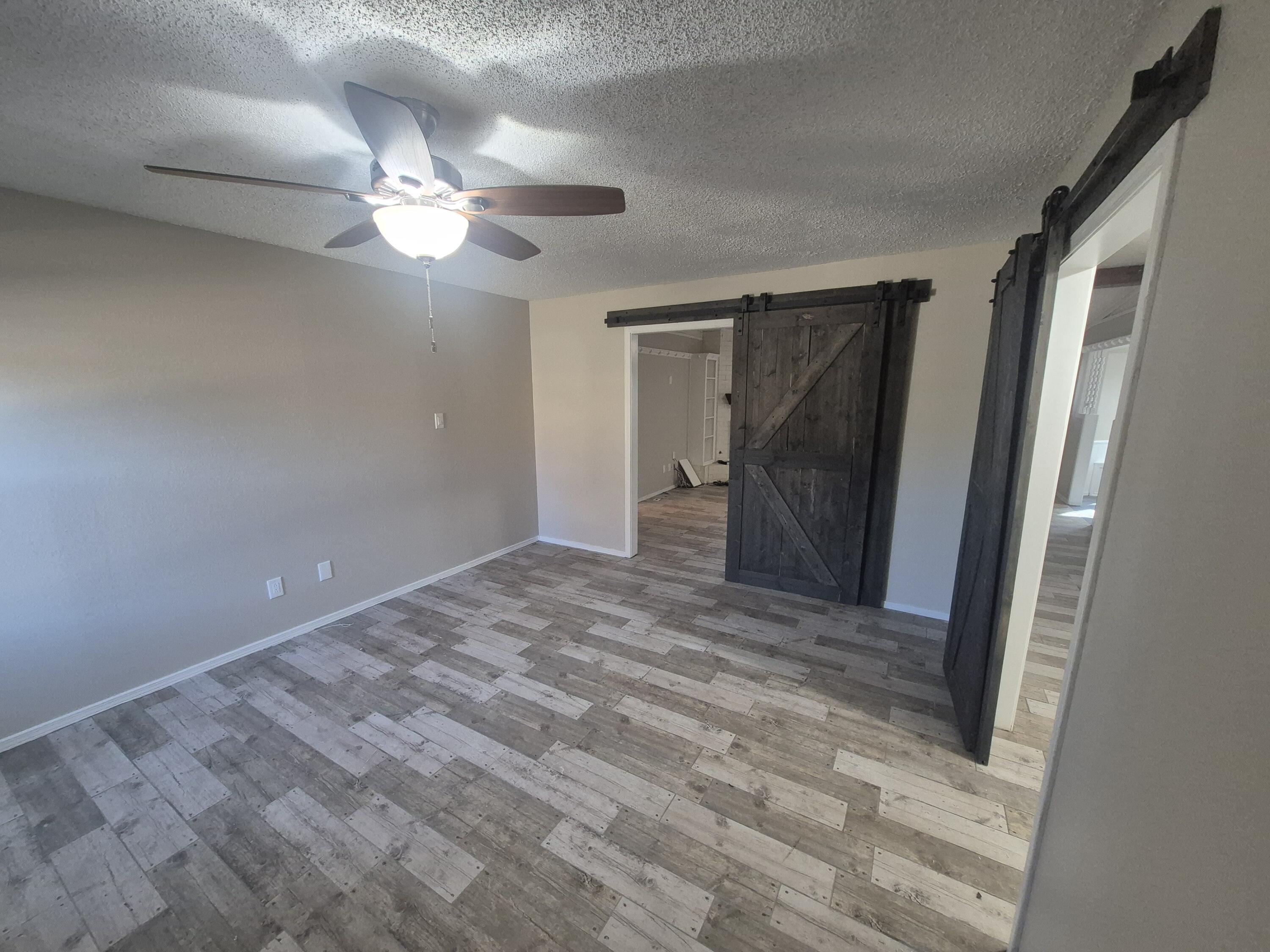 3211 94th Street Lubbock, TX 79423 - Photo 5 of 24 a view of empty room with wooden floor