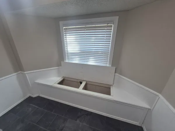 a bathroom with a bathtub and a window