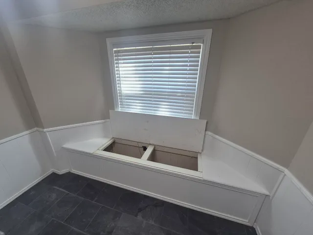 a bathroom with a bathtub and a window
