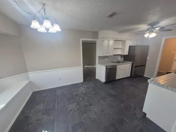 a view of a kitchen with a sink and dishwasher