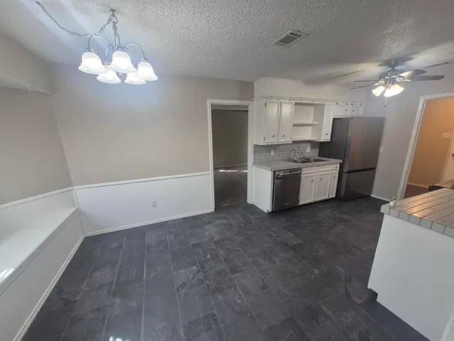 a view of a kitchen with a sink and dishwasher