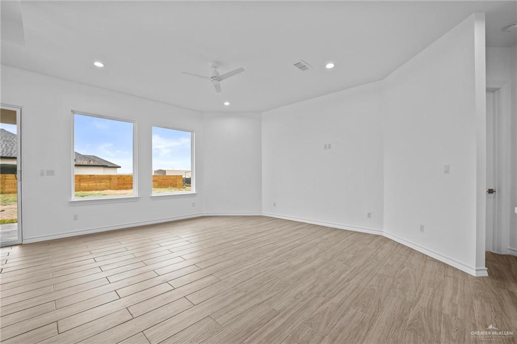 2716 East Conroe Road Edinburg, TX 78542 - Photo 8 of 31 Spare room featuring light wood-style flooring, recessed lighting, and a ceiling fan