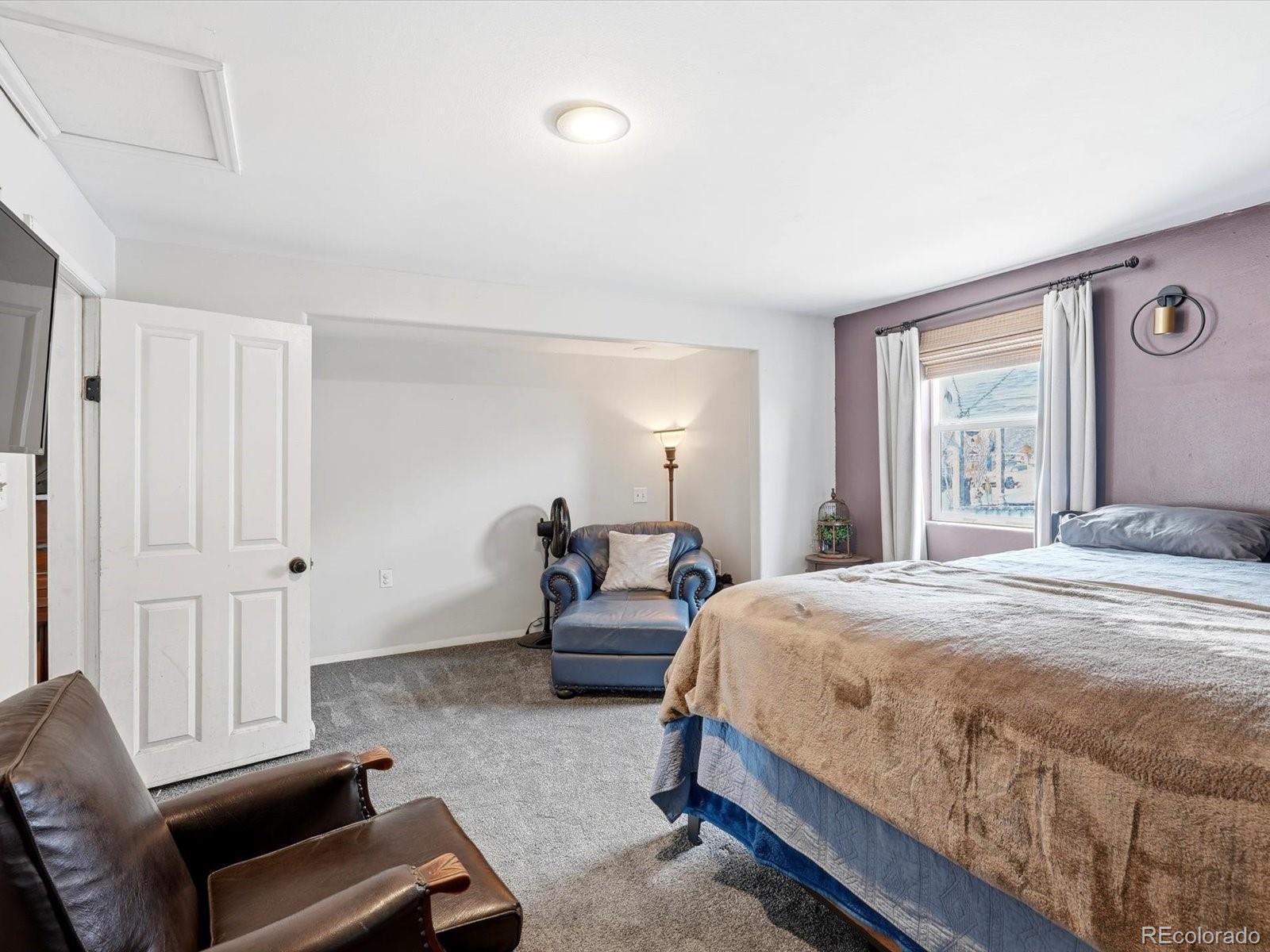 360 South 7th Avenue Brighton, CO 80601 - Photo 22 of 43 a bedroom with a bed and wooden floor