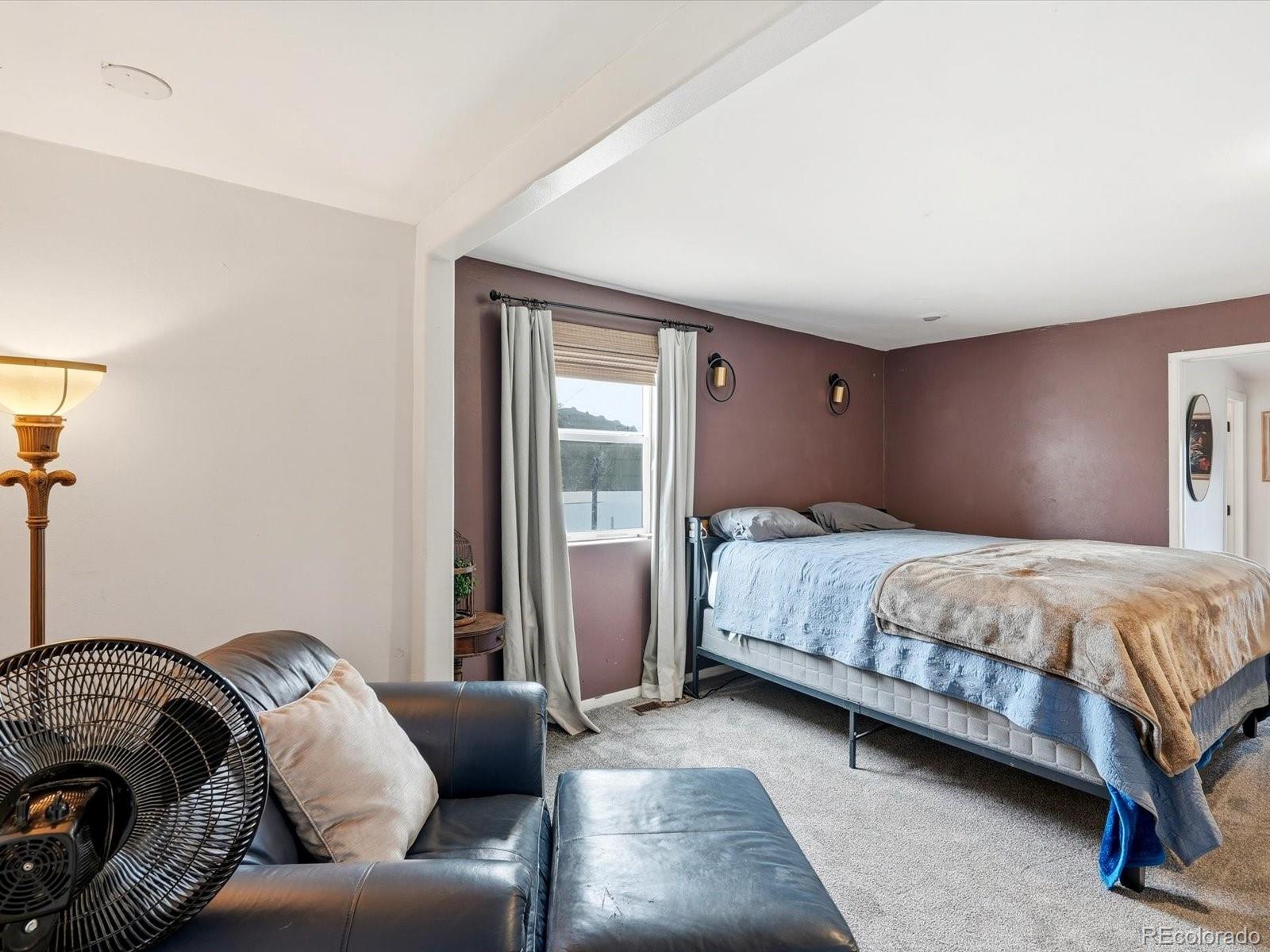 360 South 7th Avenue Brighton, CO 80601 - Photo 25 of 43 a bedroom with a bed couch and a window