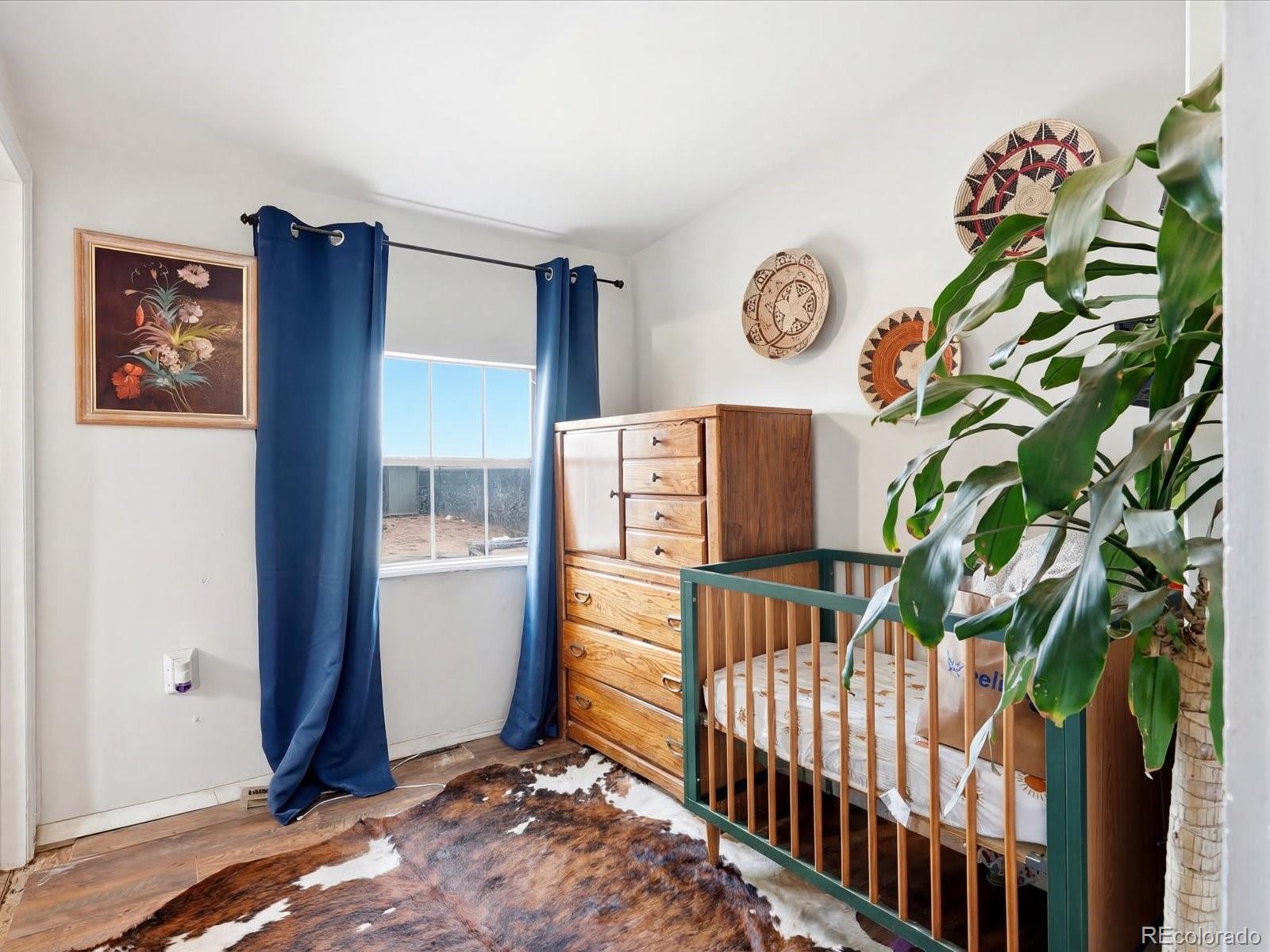 360 South 7th Avenue Brighton, CO 80601 - Photo 26 of 43 a bedroom with furniture and a window