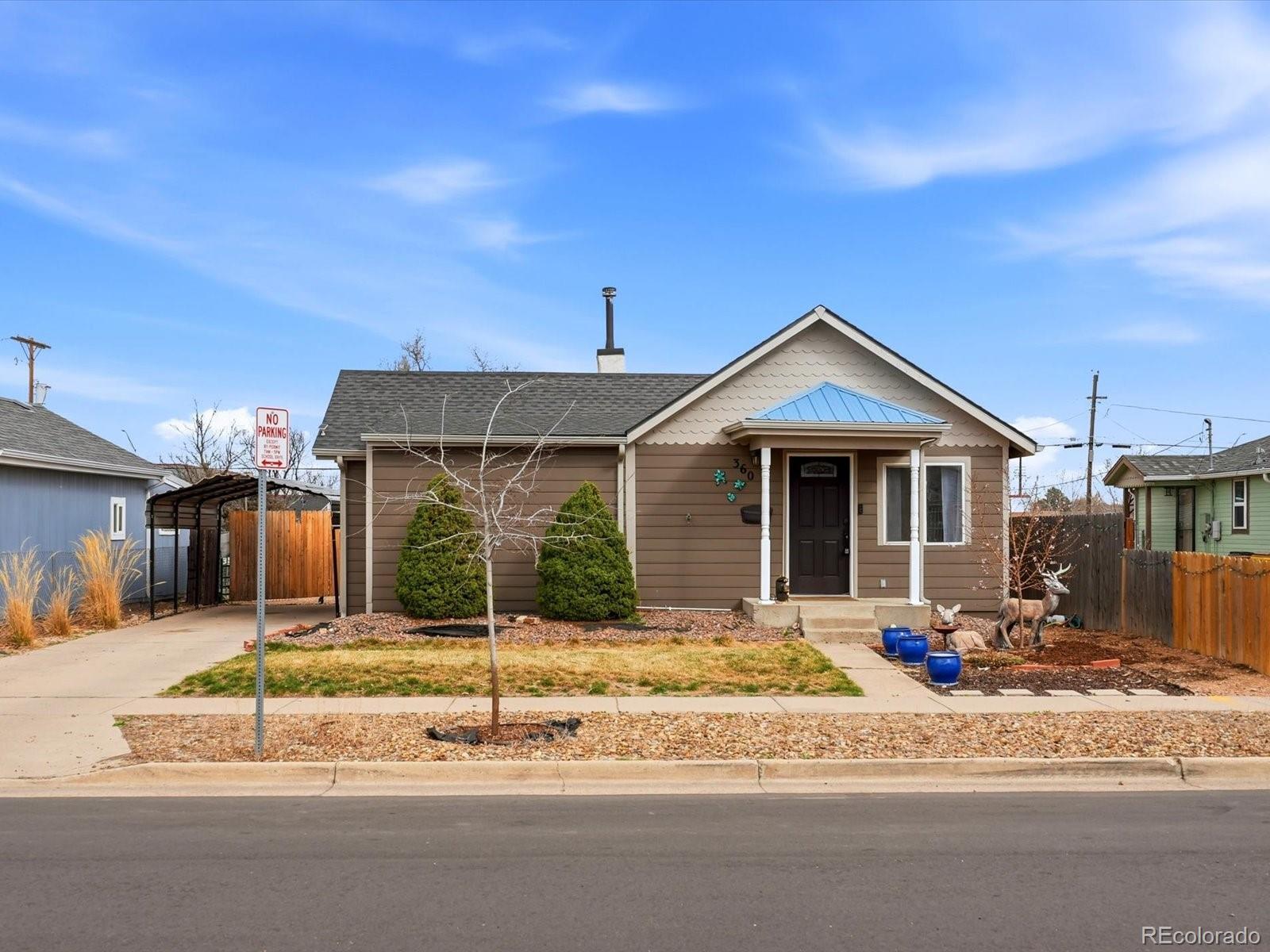 360 South 7th Avenue Brighton, CO 80601 - Photo 3 of 43 a front view of a house with a yard outdoor seating and garage