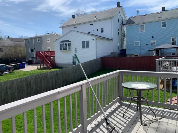 a view of a chairs and table in the back yard of the house