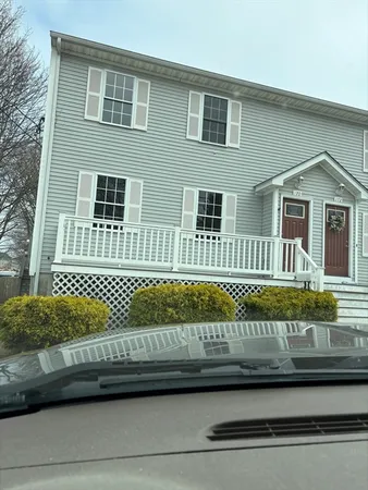 a view of a house with a wooden deck
