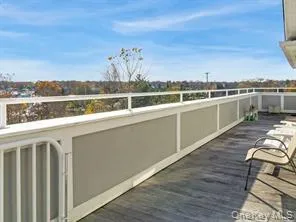 a very nice looking living room with a large window and dining table
