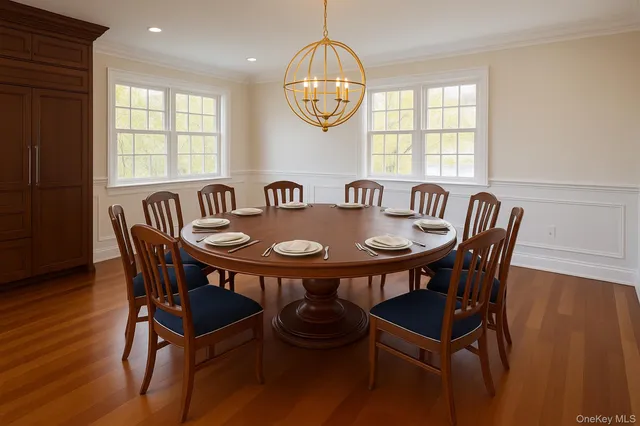 a view of a dining room with furniture and wooden floor