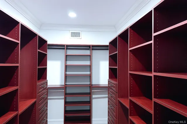 a bedroom with a large bed and wooden floor next to a window