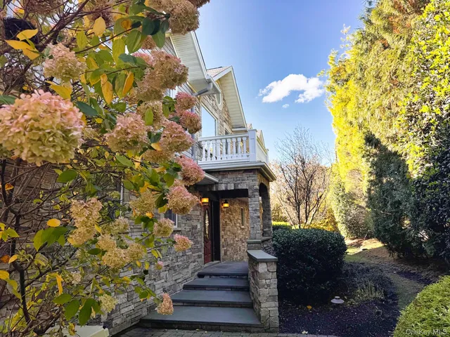 a front view of a house with a fountain